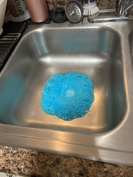 A reviewer shows an image of blue foam emerging from the disposal.