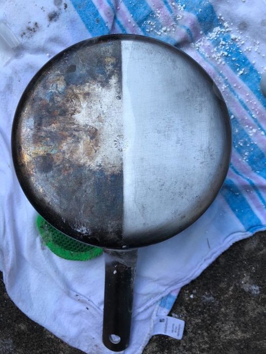A customer review photo of a pot halfway cleaned using Bar Keepers Friend