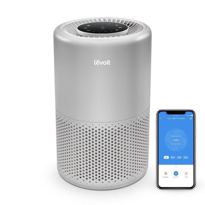 A detailed view of the air purifier, paired with the mobile app displayed on a smartphone