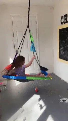 The reviewer’s kids swinging indoors in the room