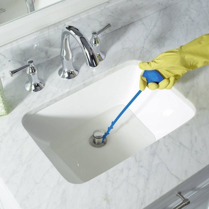 The drain cleaner tool in use, effectively clearing the drain