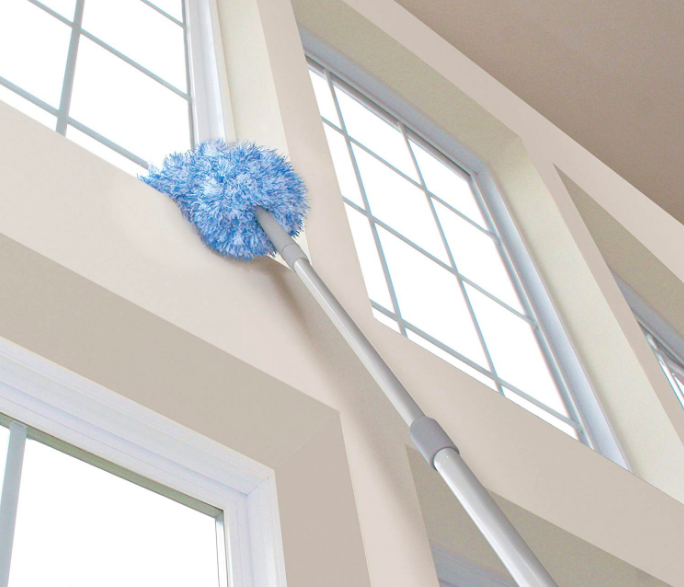 A close-up view of high windows being dusted with the product.