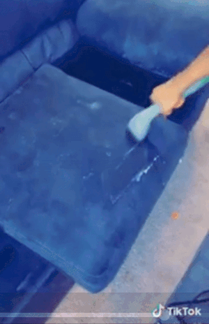 A GIF showing a reviewer using the cleaner to restore a couch cushion to its original, like-new condition
