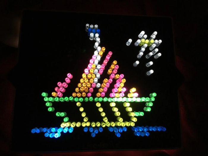 A reviewer shares a completed Lite-Brite template featuring a boat design.