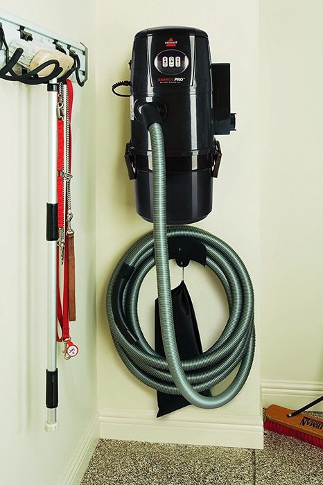 The shop vac mounted securely on the wall