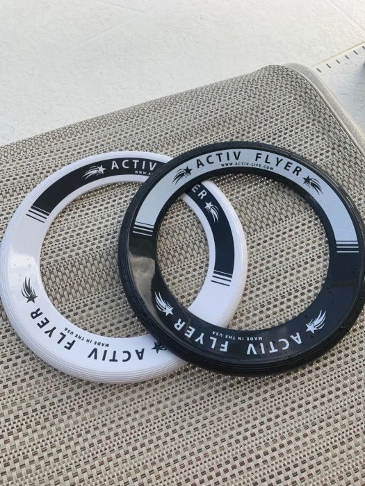 A reviewer's photo showcasing white and black flying rings.