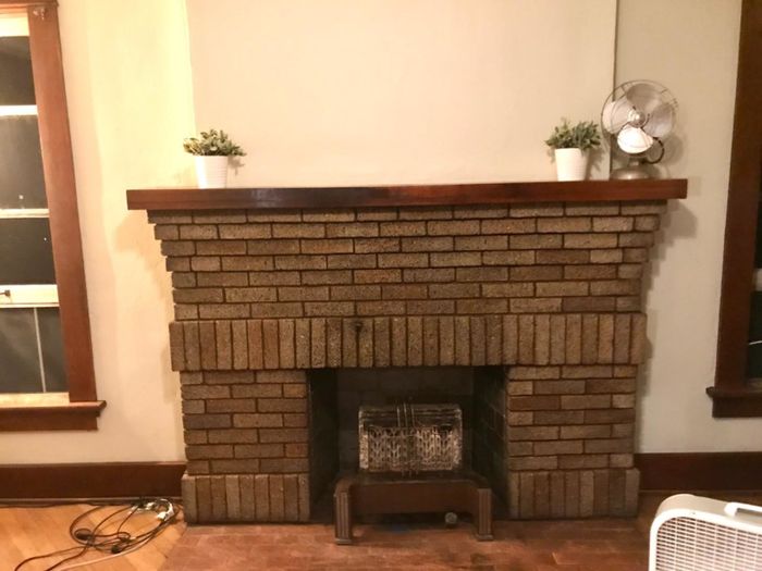 A customer review photo of a fireplace mantel completely free of soot stains after using the fireplace cleaner