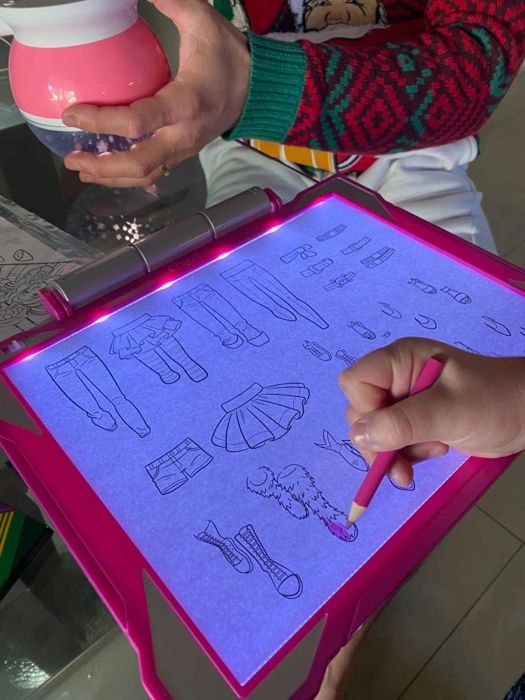 Reviewer's child drawing on the glowing tracing pad