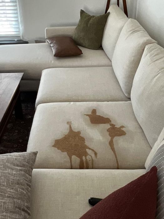 Couch with a large stain on it