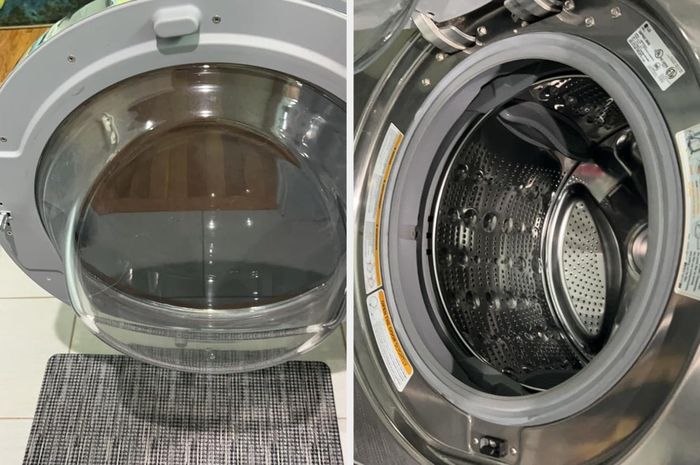 A close-up of a front-loading washing machine with its door open, revealing the drum inside