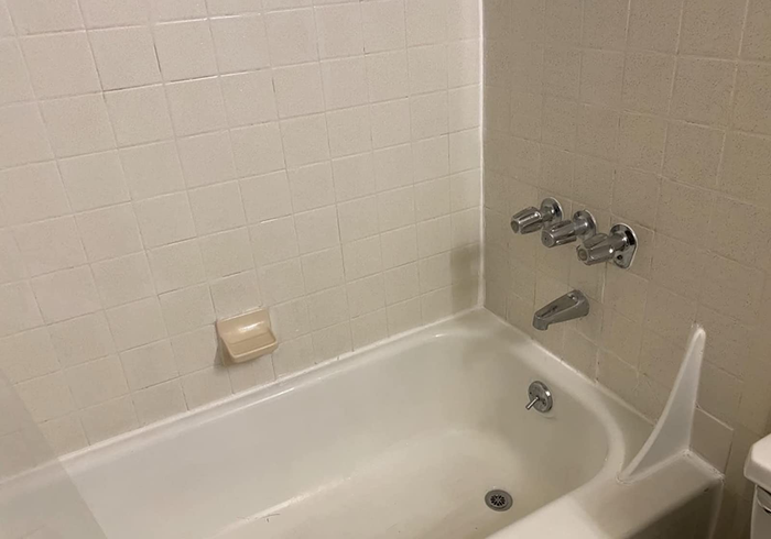 A reviewer's after photo showing the mold completely removed from the shower.
