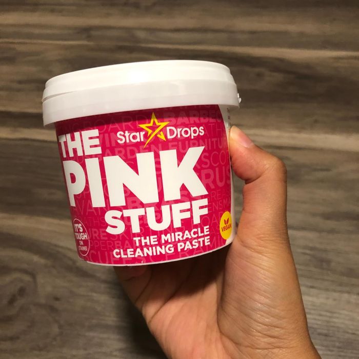 A reviewer showcasing The Pink Stuff in their hand