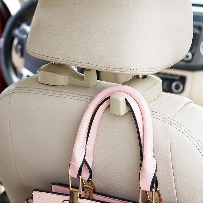 A hook attached to the back of a car seat, with a bag hanging from it.