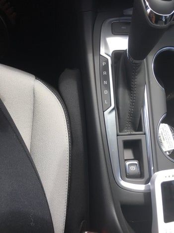 A small black seat gap filler positioned between the car seat and console