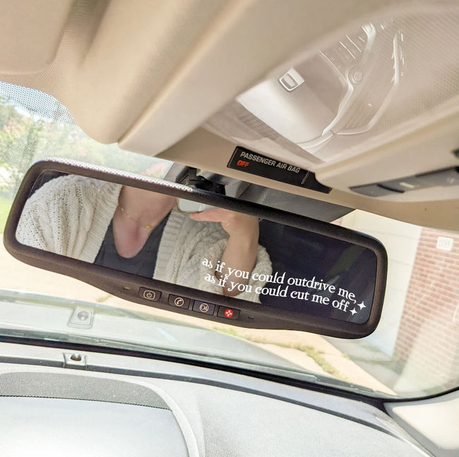 A car mirror decal with the words