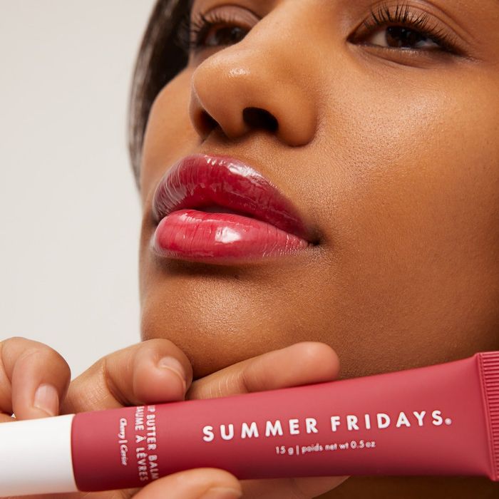 A close-up of someone applying Summer Fridays lip balm, emphasizing their smooth and glossy lips.