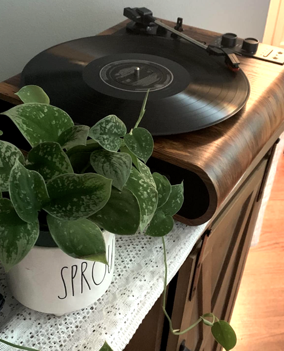 A reviewer's image of the player set up on a shelf with a record playing