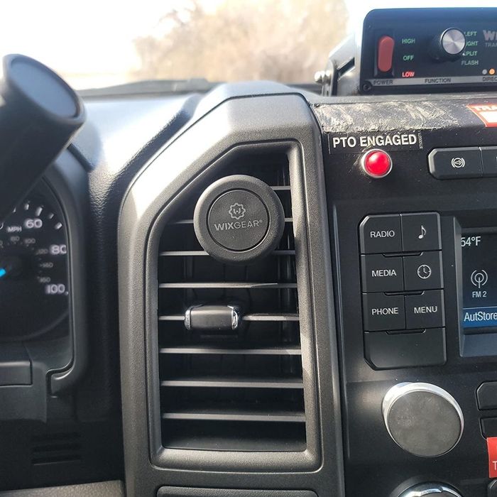 A reviewer’s photo showing the magnetic base attached to their car's air vent.