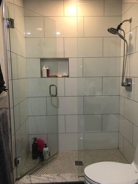 A reviewer’s sparkling, pristine shower with glass doors.