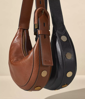 A pair of brown and black shoulder bags, featuring a buckle and gold stud accents.
