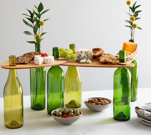The three wine topper boards displayed, held up by six bottles.
