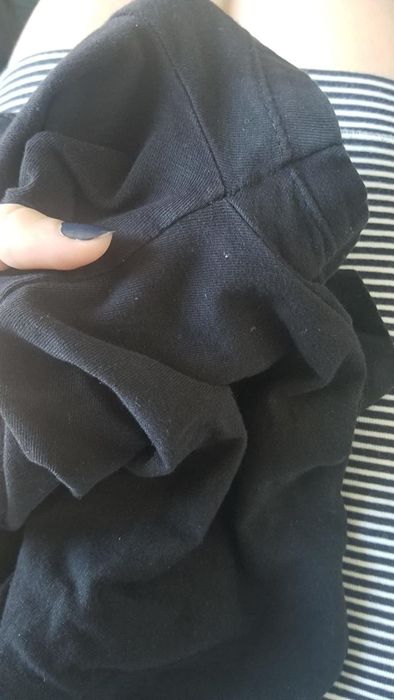 An after image of the same black shirt, now free of the white deodorant stains.