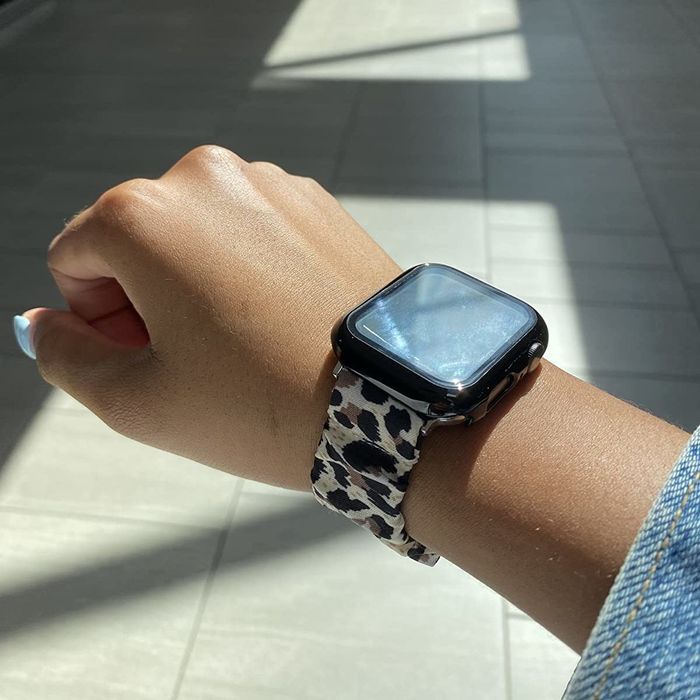 A reviewer showcasing the scrunchie band in a bold leopard print.