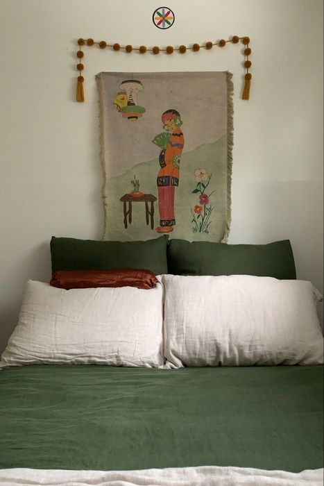 A photo showcasing a neatly made bed with two white pillows resting on it.