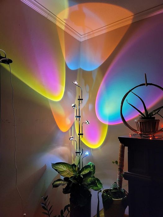 A corner of a room showing a range of colorful light halos on the walls