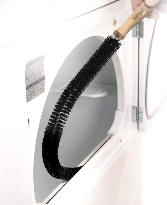 A long, thin brush cleaning the interior of a dryer's lint trap.