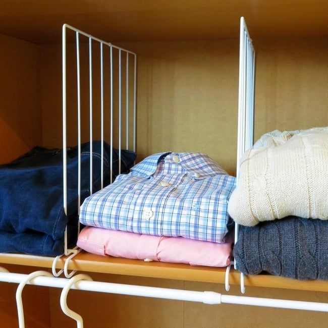 The white wire dividers neatly separating button-up shirts and sweaters.