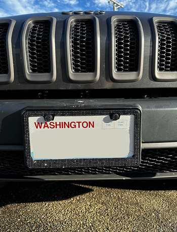 A black bedazzled license plate frame affixed to a car.