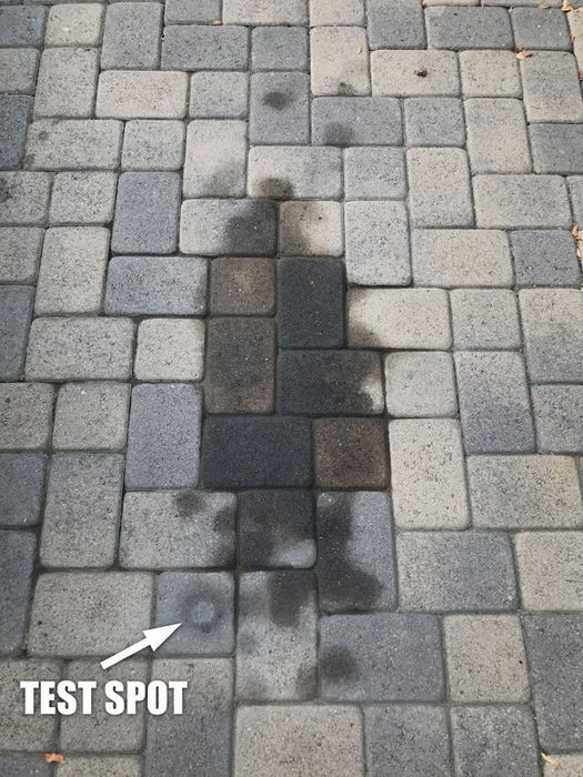 A large stain on the reviewer's paver stones, along with a clean test spot to show the effectiveness