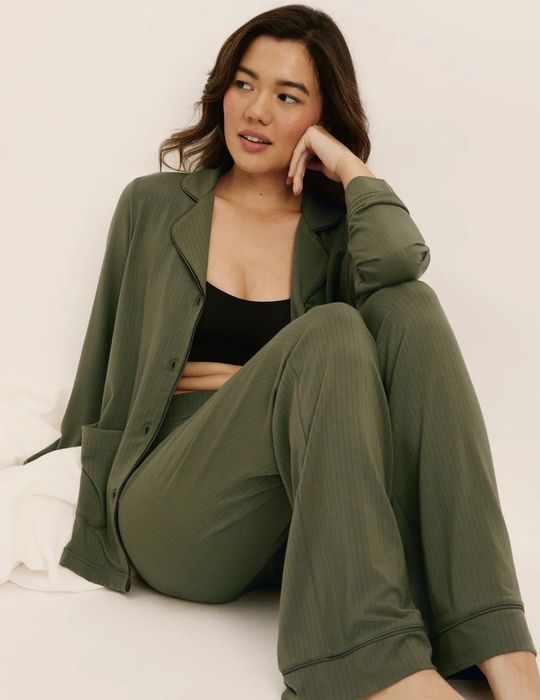 A person relaxes in a matching loungewear set, paired with a black top, featured in a shopping article.