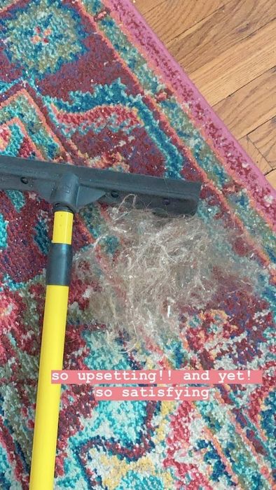 A Mytour editor's carpet with a hairball lying beside the broom 