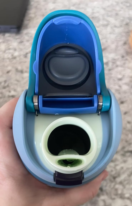 A reviewer demonstrating the Owala lid with both the straw and chug features for easy sipping or gulping.
