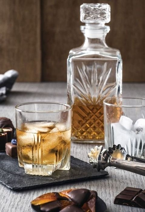 A crystal decanter paired with a set of rocks glasses
