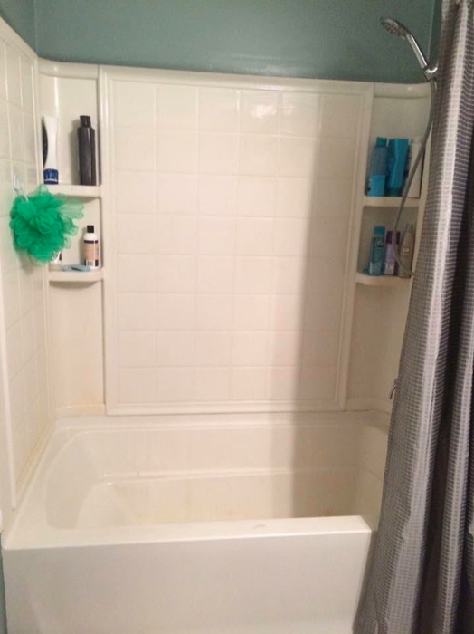 The same reviewer’s bathtub and shower, now spotless and free from any red rust stains.