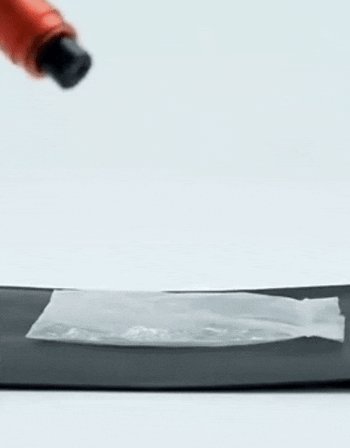 A model using the device to break the window and cut through a seatbelt