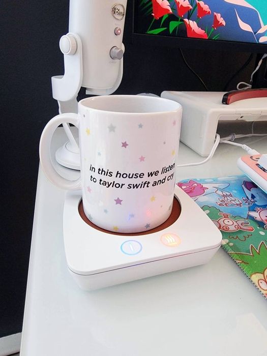 A mug resting on a warmer with the text: