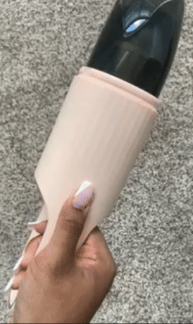 A GIF showing a reviewer turning on the pink vacuum.
