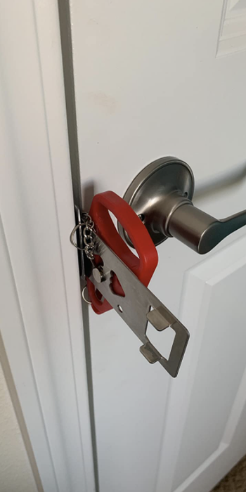 A close-up of the portable lock on a door.