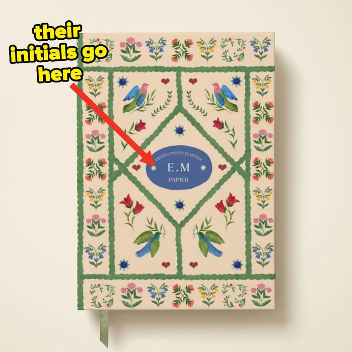A decorative planner featuring a floral and bird pattern, with a customizable section for initials highlighted by text