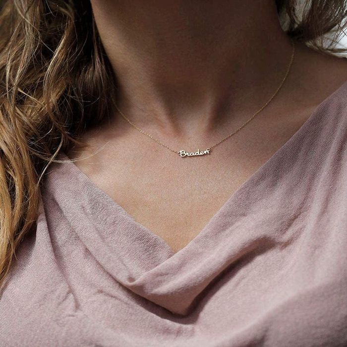 A model wearing a necklace with the name Braden on it