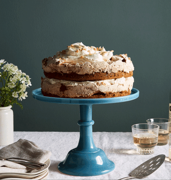 A gif showing the cake stand changing colors, followed by a hand lifting a glass cloche off a beautifully decorated cake.