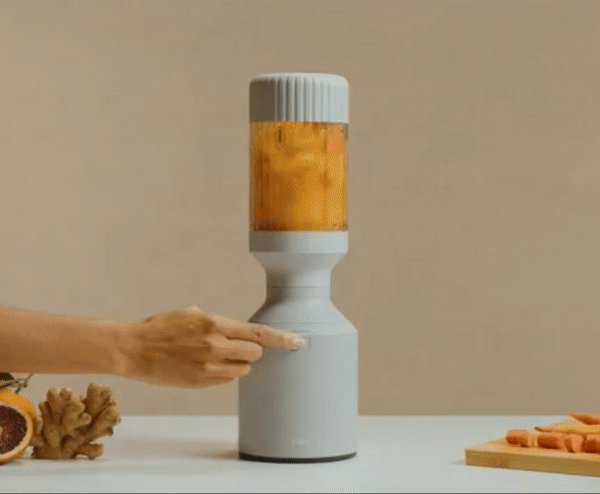 A gif showing someone starting the blender to make a smoothie.