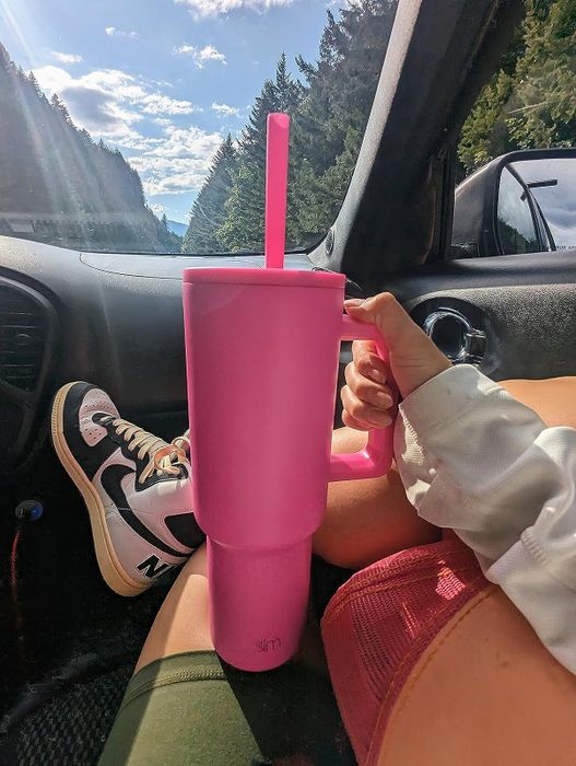 another reviewer holding the pink tumbler