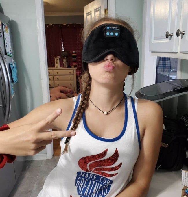 A reviewer wearing the sleeping eye mask.