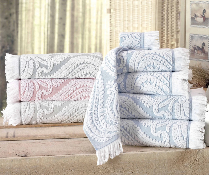 A stack of towels in various colors arranged neatly on top of one another.