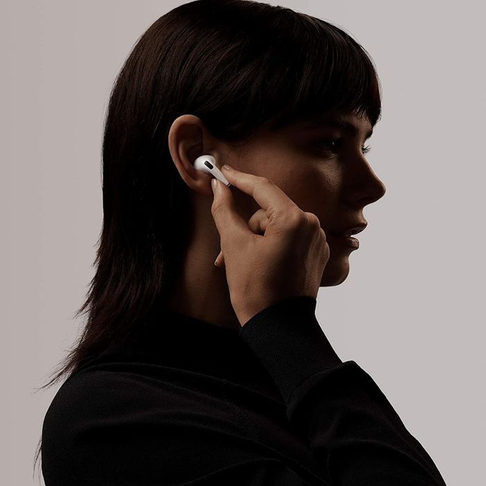 A model wearing the AirPods in their right ear